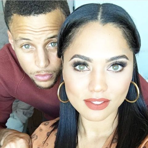 Riley Curry's parents, Stephen Curry and Ayesha Curry posing for the camera